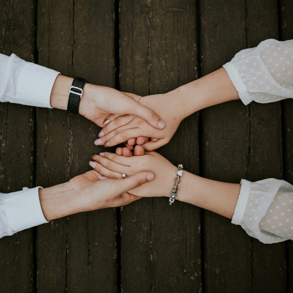 Two people holding hands
